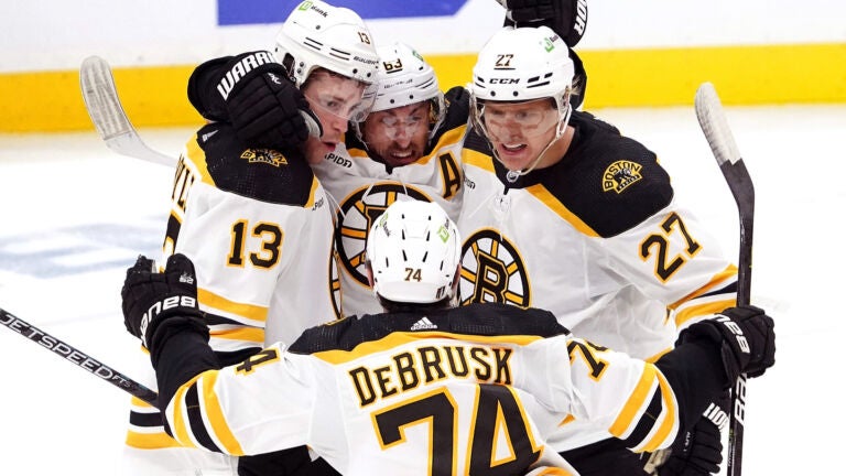 Bruins left wing Brad Marchand (63) and teammates celebrate Coyle’s goal for a 2-0 lead during the second period.