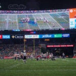 The New England Patriots new giant scoreboard had plenty of room for ads as well as the game. The New England Patriots host the Houston Texans in a NFL pre-season exhibition game on August 10, 2023 at Gillette Stadium in Foxboro, MA.