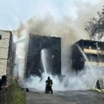 A house on fire being extinguished.