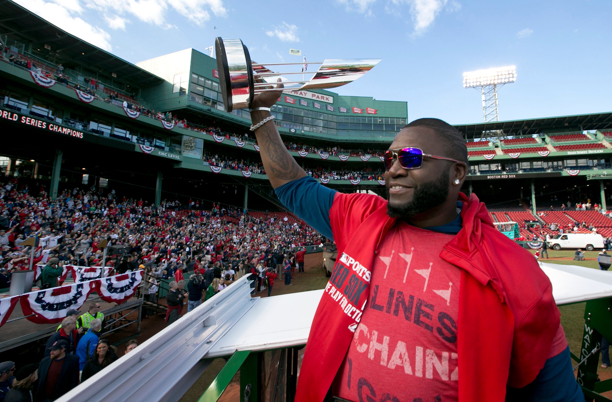 Boston Red Sox DH David Ortiz holds the MVP trophy at Fenway Park at the start of the 2013 World Series Rolling Rally victory parade in Boston on Saturday, Nov. 2, 2013.