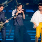 Kevin Jonas, Joe Jonas, and Nick Jonas perform on stage at TD Garden in Boston.