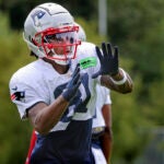 New England Patriots wide receiver Demario Douglas catching a pass during practice on the Gillette Stadium practice field.
