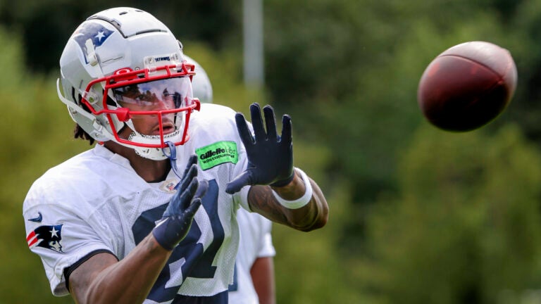 New England Patriots wide receiver Demario Douglas catching a pass during practice on the Gillette Stadium practice field.