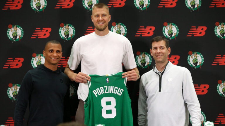 Boston Celtics head coach Joe Mazzulla (cq) left with Newly acquired big man Kristaps Porzingis(cq) middle and Brad Stevens (cq) right President of basketball operations , at a afternoon press-conference with their new player. They were all smiles during the presentation to Kristaps of his new Celtics Jersey.