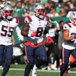 10-30-22: East Rutherford, NJ: Patriots defenders (left to right) Josh Uche (55), Ja'Whaun Bentley (8) and Myles Bryant (27) celebrate following Bentley's interception. The New England Patriots visited the New York Jets for an NFL regular season football game at MetLife Stadium