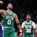 The Celtics Jayson Tatum (0) reacts after he hit a third quarter three point shot to give Boston a 73-58 lead. Teammate Marcus Smart (36) also reacts in the backround, with the 76ers Joel Embiid (21) heading for the visitor's bench in the backround at far right as Philadelphia called a timeout after the basket. The Boston Celtics hosted the Philadelphia 76ers for Game Seven of their NBA Eastern Conference Semi Final basketball series at the TD Garden.
