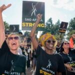 Ellen Colton, left an actor and secretary of the SAG-AFTRA and Gilda James a SAF-AFTRA board member during the New England Local members and the Massachusetts Labor Movement rally in support of the SAG-AFTRA strike at the Parkman Bandstand.