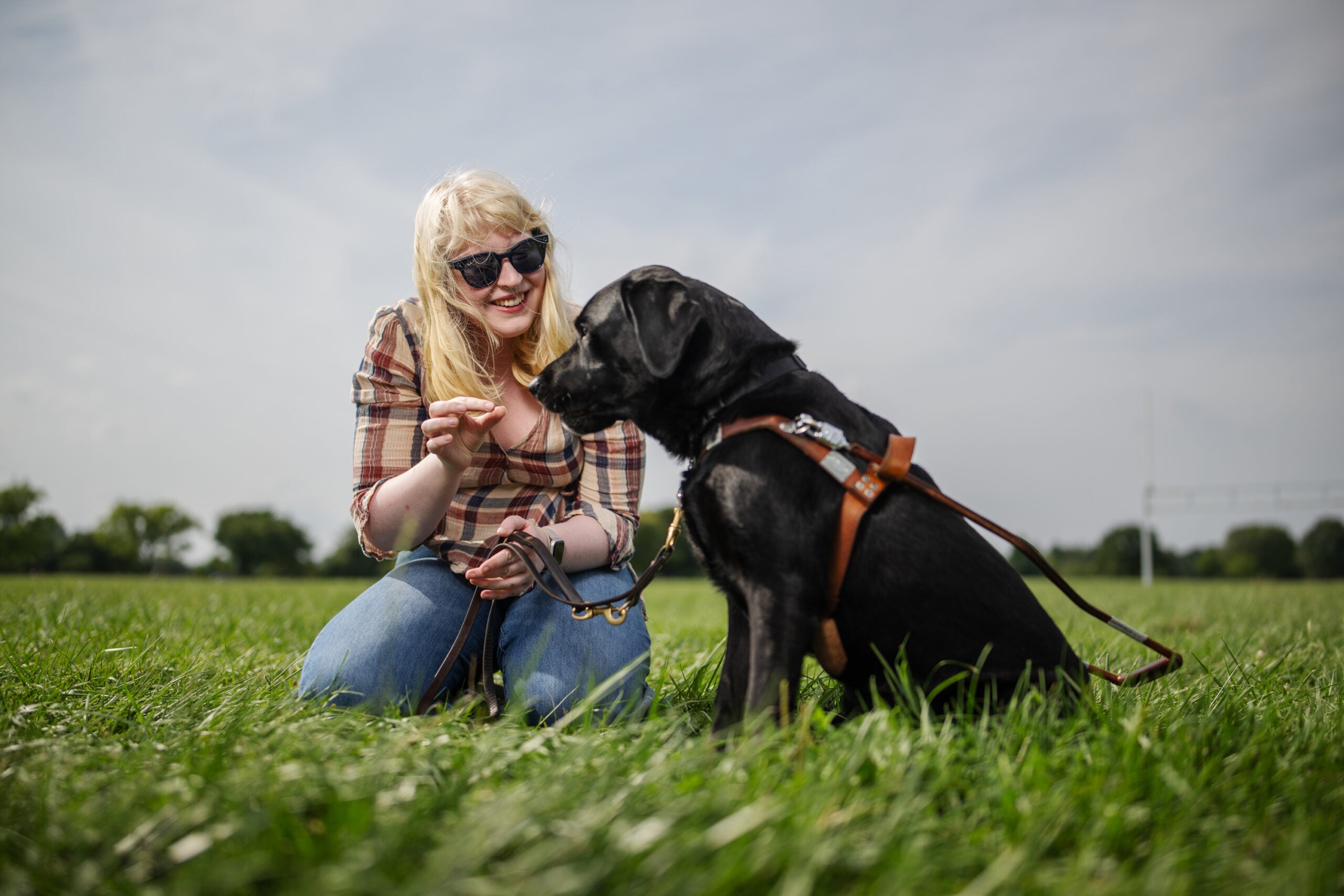 Elizabeth Schoen with black service dog Eva at Gravelly Point Park. 
