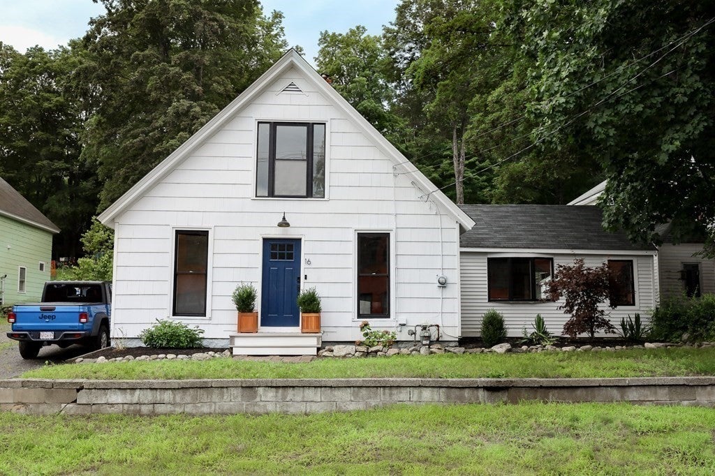 Homes for sale under $500,000...in Shirley with a blue front door and white siding. 