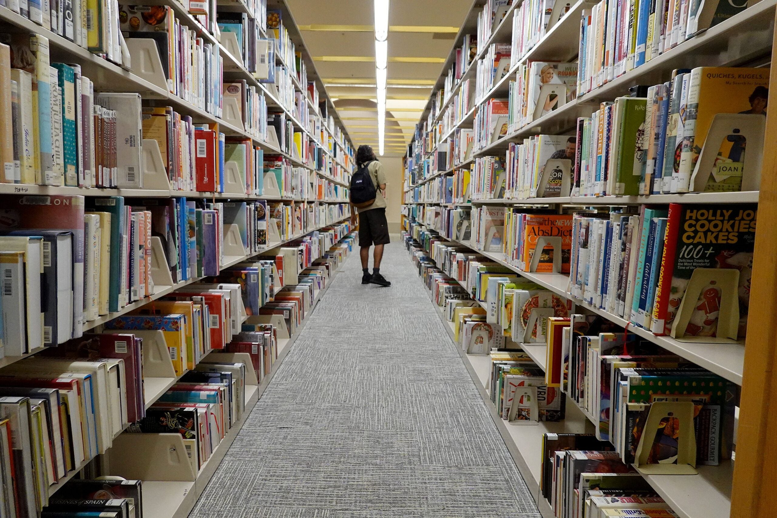 A person looks at books at a Miami-Dade Public Library on July 19, 2023 in Miami, Florida.