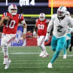 New England Patriots quarterback Mac Jones (10) carries against Miami Dolphins linebacker Bradley Chubb (2) during the fourth quarter. The New England Patriots hosted the Miami Dolphins in an NFL game on Sept. 17 at Gillette Stadium in Foxborough.