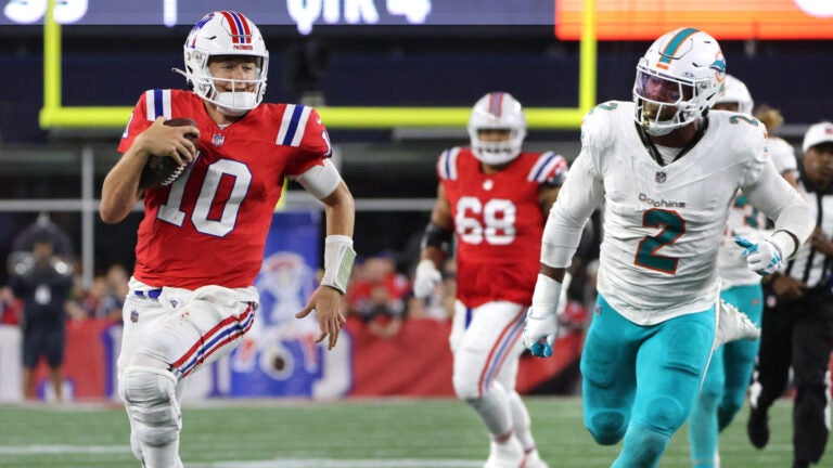 New England Patriots quarterback Mac Jones (10) carries against Miami Dolphins linebacker Bradley Chubb (2) during the fourth quarter. The New England Patriots hosted the Miami Dolphins in an NFL game on Sept. 17 at Gillette Stadium in Foxborough.