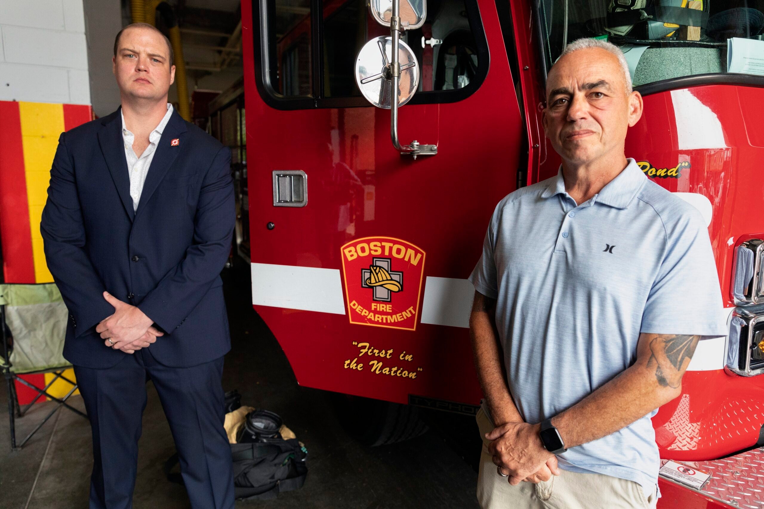 Boston firefighter Daniel Ranahan and retired Brockton deputy fire chief Joe Marchetti pose in front of a firetruck at the Engine 28 fire station in Jamaica Plain. 