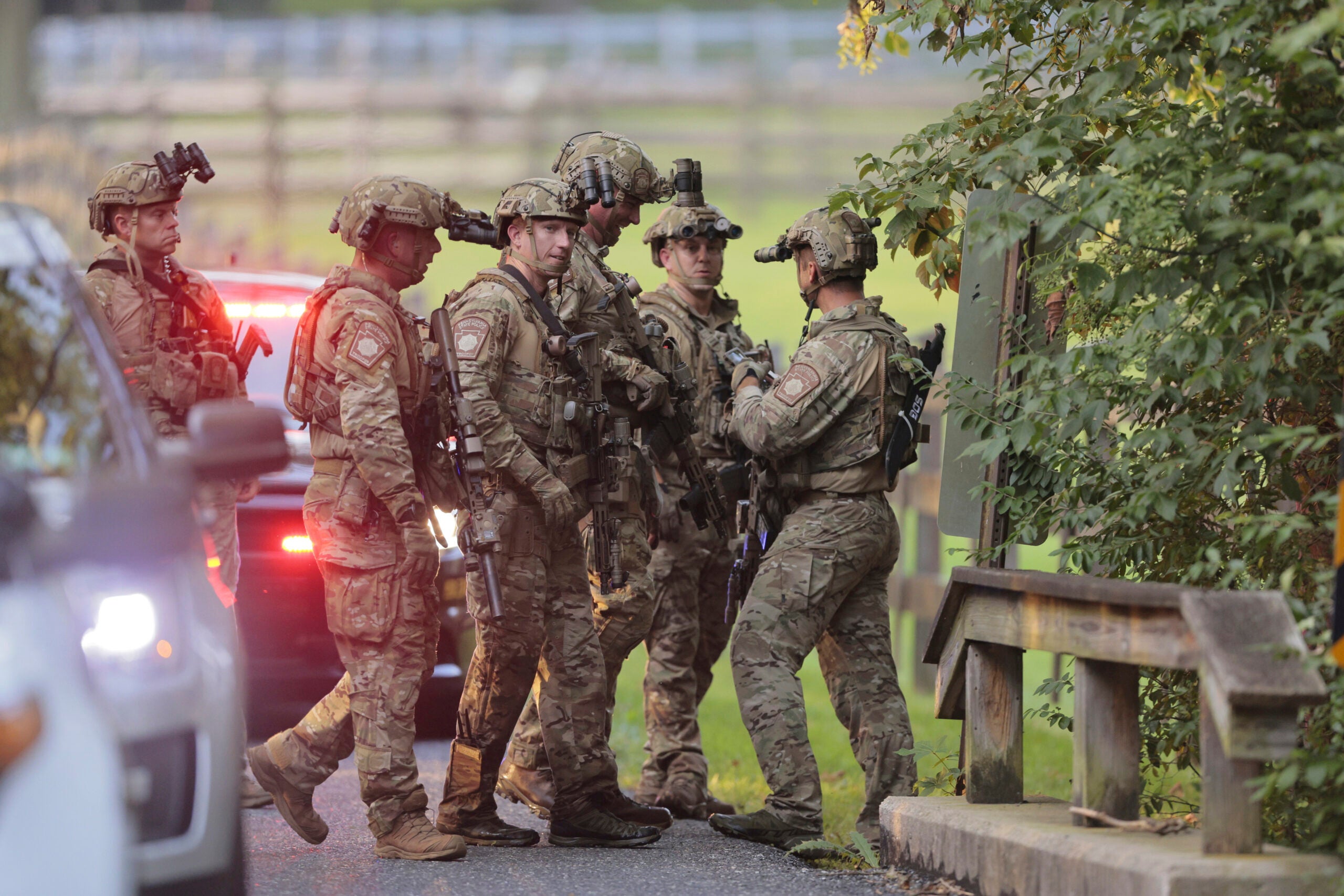 Pennsylvania State police search the woods and a creek in Pennsbury Township, Pa.