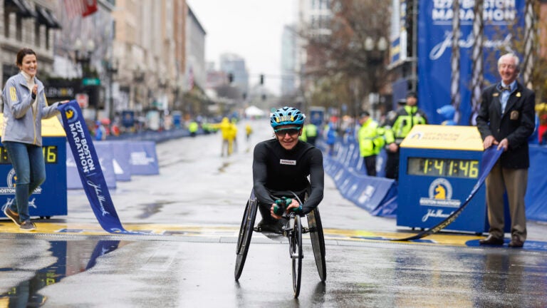 Susannah Scaroni smiles after breaking the tape to win the women's wheelchair division of the 127th Boston Marathon.
