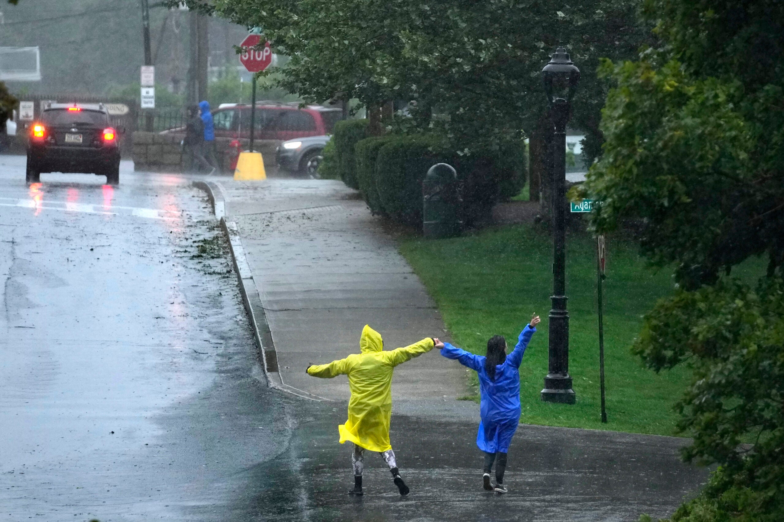 Two people dance in the rain during storm Lee.