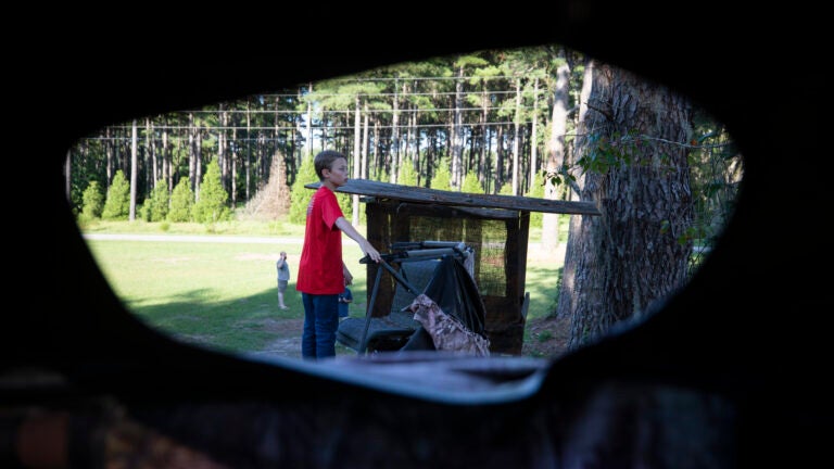 Dylan Hysong, 14, climbs up to the top of a deer stand.