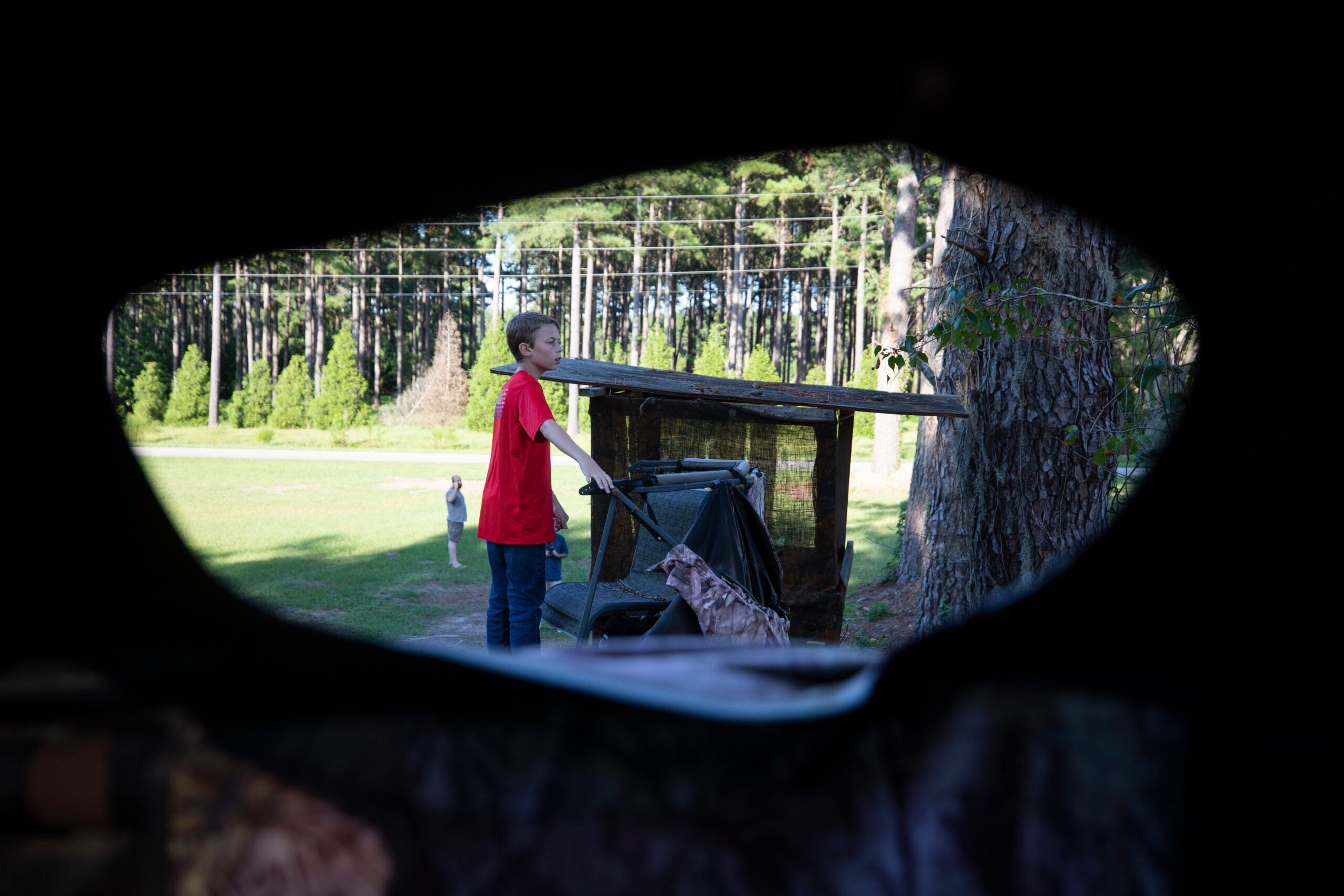 Dylan Hysong, 14, climbs up to the top of a deer stand.