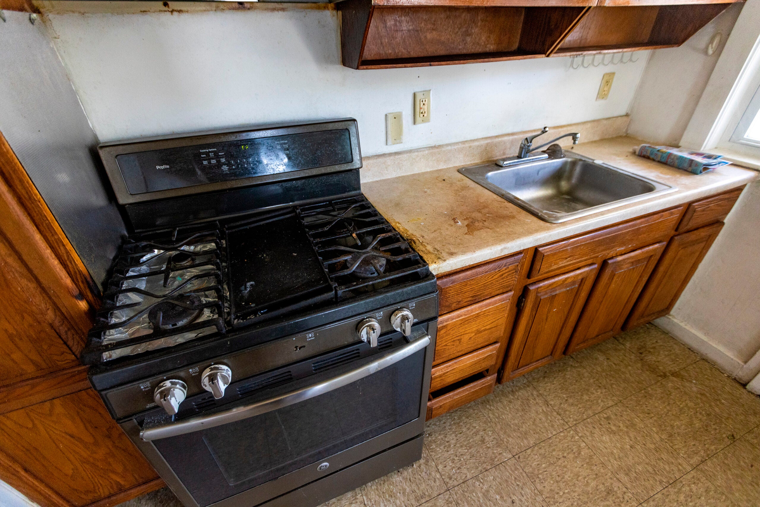 A kitchen in need renovation is seen at the Lexington Gardens public housing complex in Watertown, Mass.
