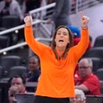 Connecticut Sun head coach Stephanie White raises her hands up.