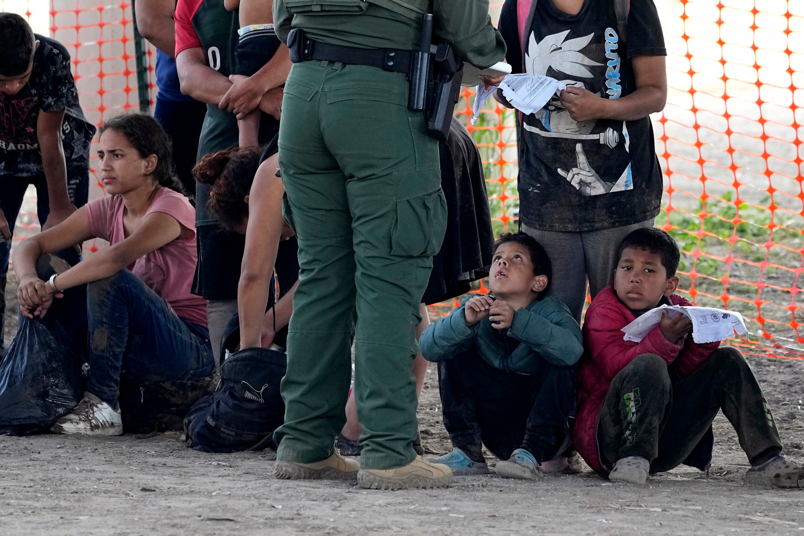 Migrants who crossed into the U.S. from Mexico wait to be processed by U.S. Border Patrol agents in Eagle Pass, Texas.