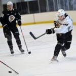 Defenseman Mason Lohrei, right fires a shot on goal during a Bruins development camp scrimmage at Warrior Arena.