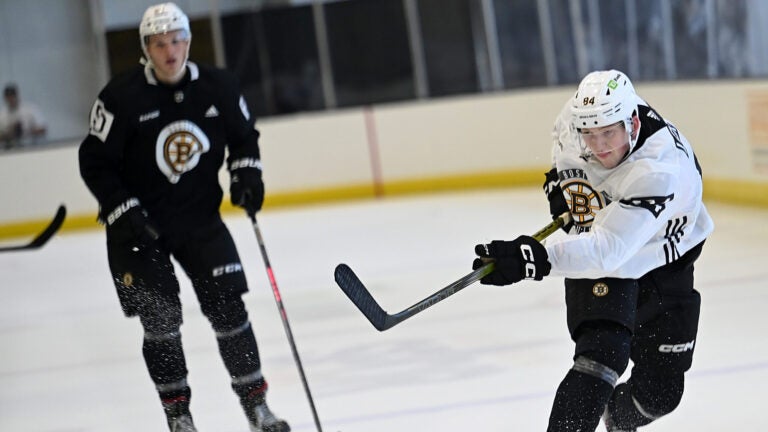 Defenseman Mason Lohrei, right fires a shot on goal during a Bruins development camp scrimmage at Warrior Arena.