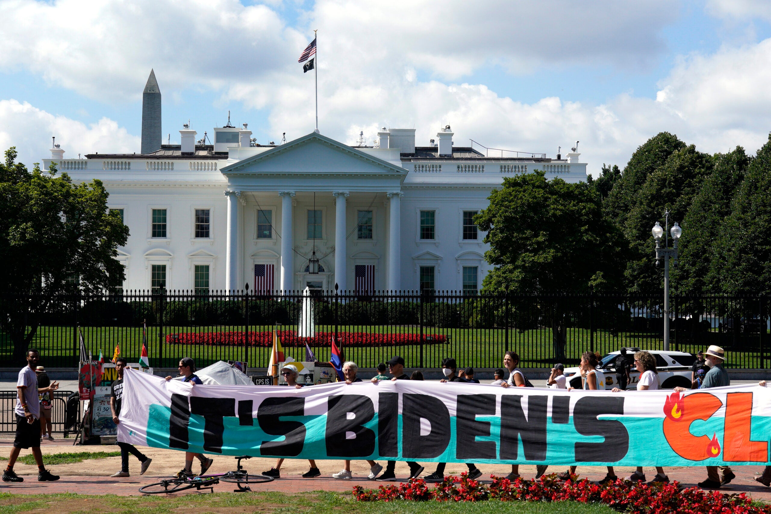 Climate activists rally in front of the White House at Lafayette Square.