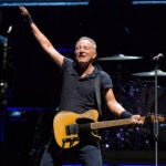 Bruce Springsteen and The E Street Band perform on stage.