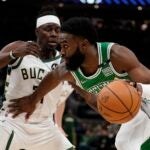 Boston Celtics' Jaylen Brown tries to get past Milwaukee Bucks' Jrue Holiday during the second half of an NBA basketball game Thursday, April 7, 2022, in Milwaukee. The Bucks won 127-121.