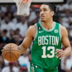 Boston Celtics guard Malcolm Brogdon (13) dribbles the ball during Game 4 of the NBA basketball playoffs Eastern Conference finals against the Miami Heat, Tuesday, May 23, 2023, in Miami.