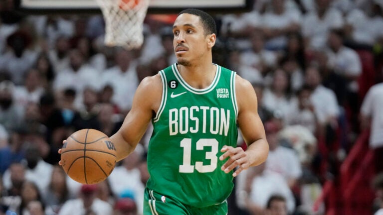 Boston Celtics guard Malcolm Brogdon (13) dribbles the ball during Game 4 of the NBA basketball playoffs Eastern Conference finals against the Miami Heat, Tuesday, May 23, 2023, in Miami.