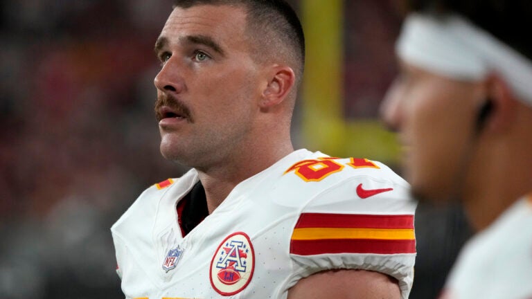 Kansas City Chiefs tight end Travis Kelce watches from the sidelines.