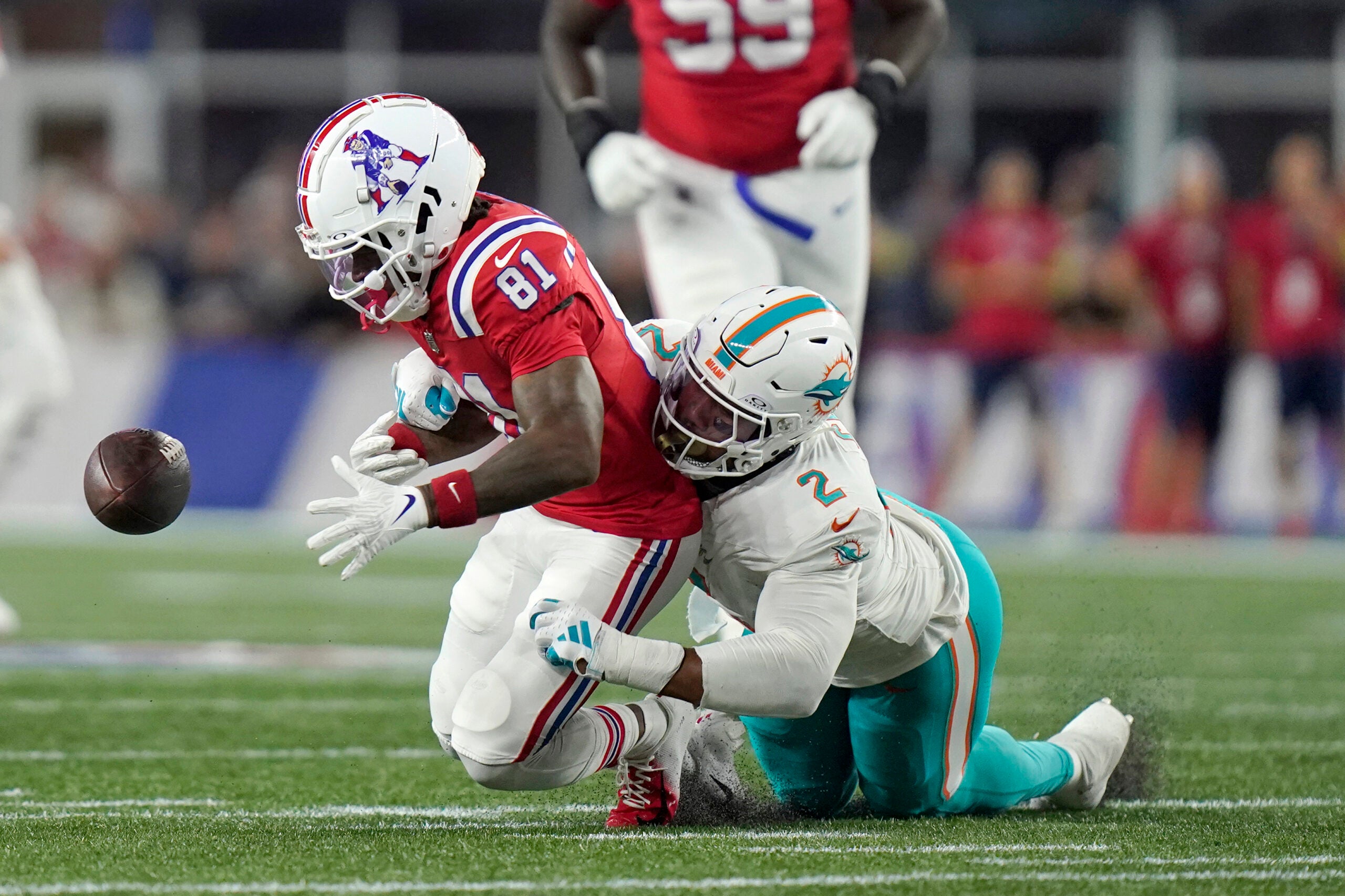 Miami Dolphins linebacker Bradley Chubb, right, strips the ball from the hands of New England Patriots wide receiver Demario Douglas (81) during the first half of an NFL football game, Sunday, Sept. 17, 2023, in Foxborough, Mass.