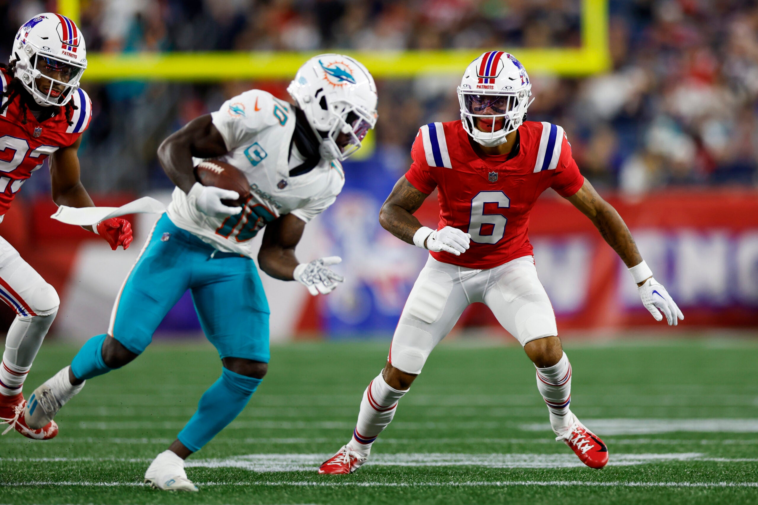 New England Patriots cornerback Christian Gonzalez (6) prepares to tackle Miami Dolphins wide receiver Tyreek Hill (10) during the second half of an NFL football game against the Miami Dolphins on Sunday, Sept. 17, 2023, in Foxborough, Mass.