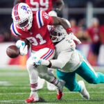 Miami Dolphins linebacker Bradley Chubb, right, strips the ball from the hands of New England Patriots wide receiver Demario Douglas (81) during the first half of an NFL football game, Sunday, Sept. 17, 2023, in Foxborough, Mass.
