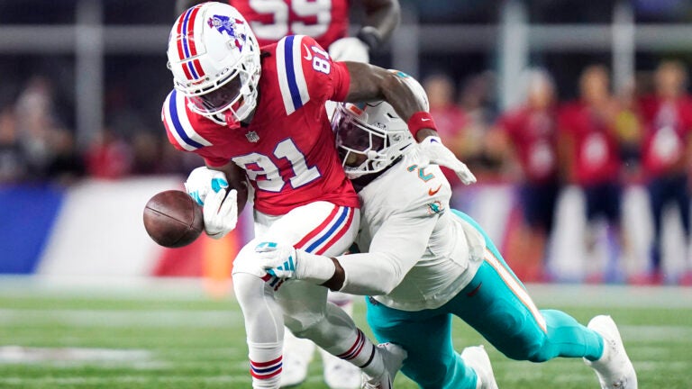 Miami Dolphins linebacker Bradley Chubb, right, strips the ball from the hands of New England Patriots wide receiver Demario Douglas (81) during the first half of an NFL football game, Sunday, Sept. 17, 2023, in Foxborough, Mass.