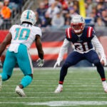 Miami Dolphins wide receiver Tyreek Hill (10) is defended by New England Patriots cornerback Jonathan Jones (31) during the first half of an NFL football game, Sunday, Jan. 1, 2023, in Foxborough, Mass.