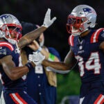 New England Patriots wide receiver Kendrick Bourne (84) celebrates with wide receiver Demario Douglas (81) after a touchdown during the second half of an NFL football game against the Philadelphia Eagles, Sunday, Sept. 10, 2023, in Foxborough, Mass.