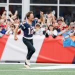 Former New England Patriots quarterback Tom Brady screams as he runs through the end zone during half time of an NFL football game against the Philadelphia Eagles, Sunday, Sept. 10, 2023, in Foxborough, Mass.