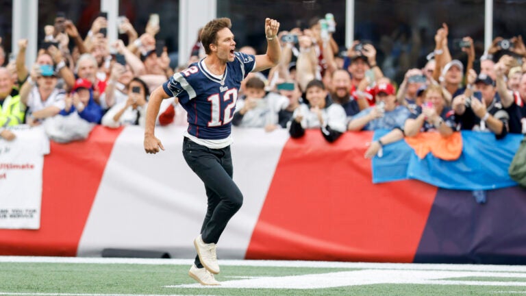 Former New England Patriots quarterback Tom Brady screams as he runs through the end zone during half time of an NFL football game against the Philadelphia Eagles, Sunday, Sept. 10, 2023, in Foxborough, Mass.