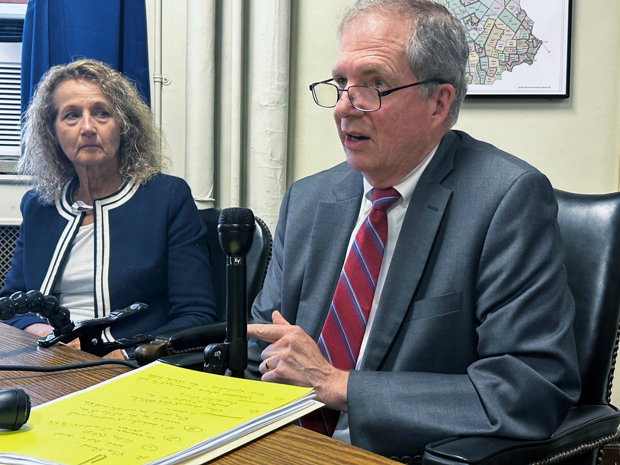 New Hampshire Deputy Secretary of State Patricia Lovejoy looks on as Secretary of State David Scanlan talks.