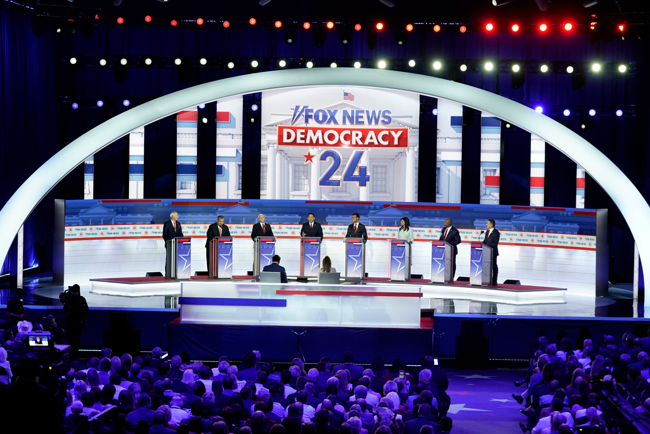 Republican presidential candidates stand at their podiums during a Republican presidential primary debate hosted by FOX News Channel.