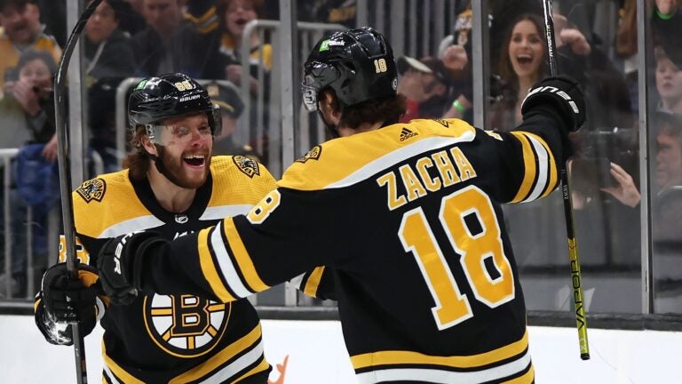 Pavel Zacha #18 of the Boston Bruins celebrates with David Pastrnak #88 after scoring a goal against the New Jersey Devils during the first period at TD Garden on April 08, 2023 in Boston, Massachusetts.