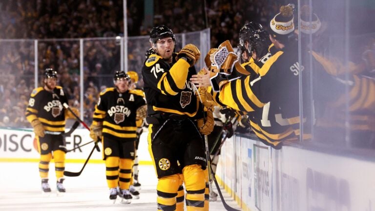 Jake DeBrusk #74 of the Boston Bruins celebrates with teammates after scoring a goal against the Pittsburgh Penguins during the third period in the 2023 Discover NHL Winter Classic at Fenway Park on January 02, 2023 in Boston, Massachusetts.
