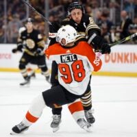 Boston Bruins' Brad Marchand (63) checks Philadelphia Flyers' Victor Mete (98) during the first period of a preseason NHL hockey game Friday, Sept. 29, 2023, in Boston.