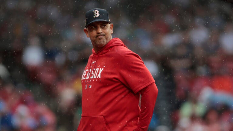 Red Sox manager Alex Cora walks back to the dugout during the sixth inning of play against the Rangers at Fenway Park.