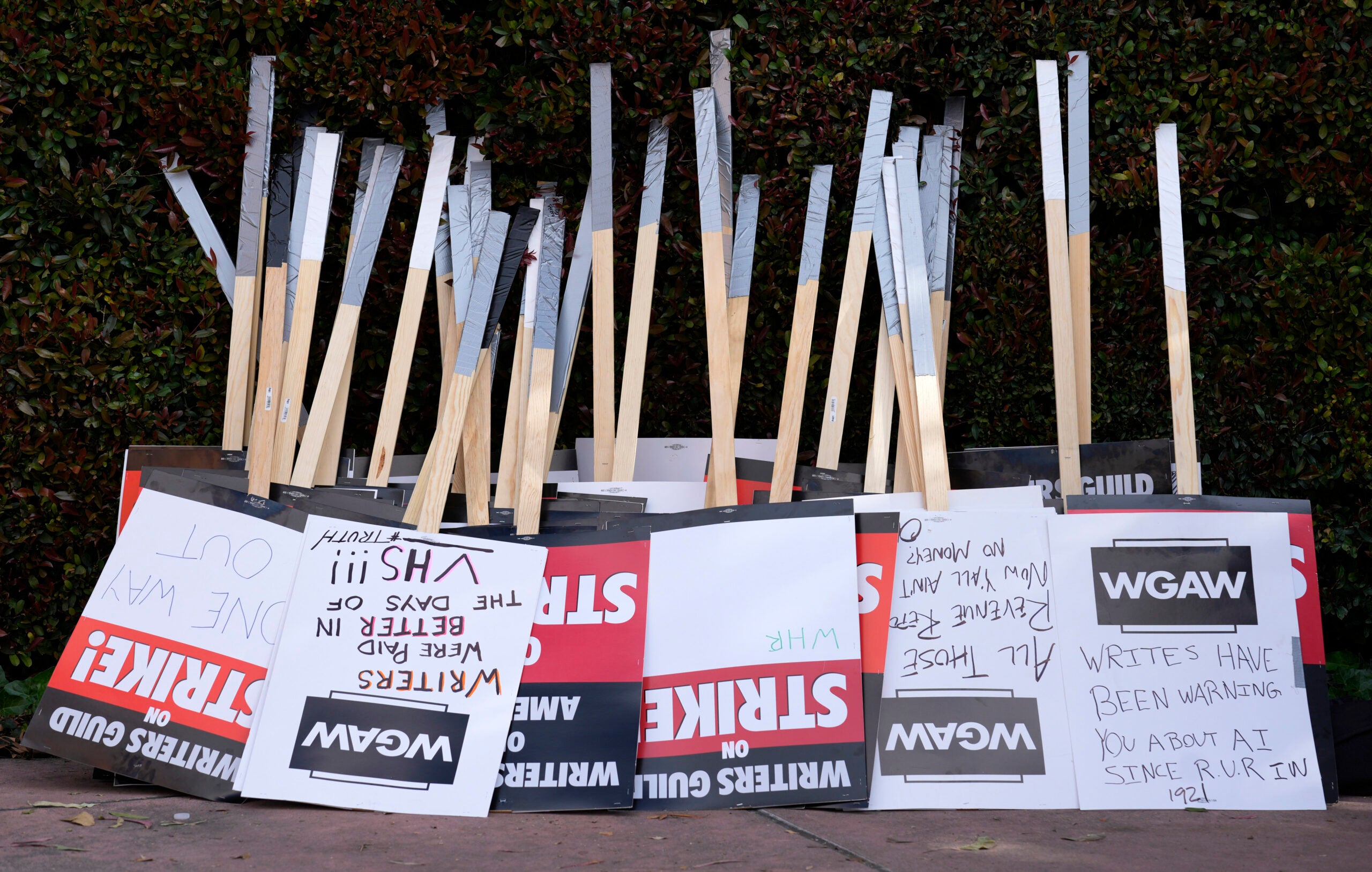 Placards are gathered together at the close of a picket.