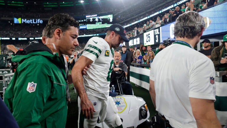 New York Jets quarterback Aaron Rodgers is helped off the field after getting injured.