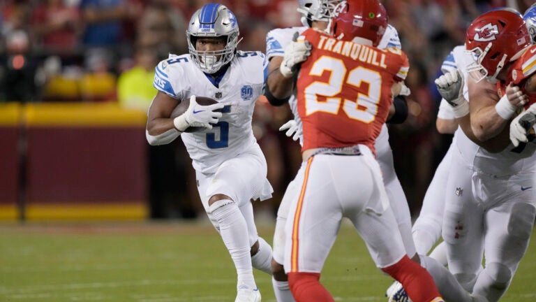 Detroit Lions running back David Montgomery runs with the ball.
